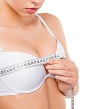 girl measures her breasts before the augmentation